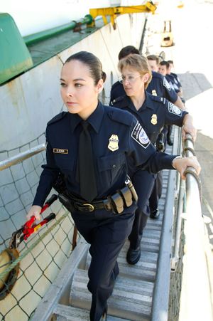 US female officers going aboard a ship.jpg